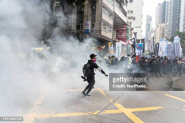 Tens of thousands of protesters marched in Hong Kong on January 1, 2020. Riot police deploy tear gas during a protest. Several protesters were...
