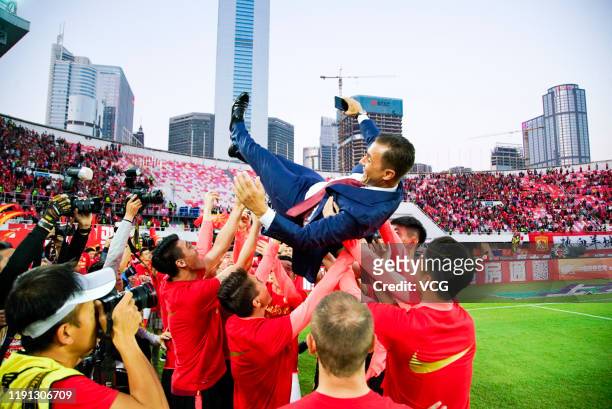 Head coach Fabio Cannavaro of Guangzhou Evergrande is thrown up in the air by his players as they celebrate winning the 2019 Chinese Super League...