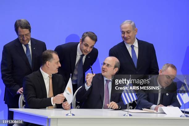 Greek Prime Minister Kyriakos Mitsotakis , his Israeli counterpart Benjamin Netanyahu and Cypriot President Nikos Anastasiadis stand behind Cypriot...