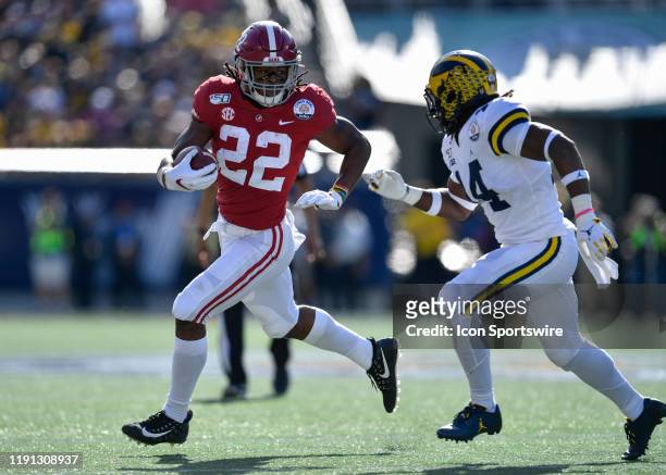 Alabama Crimson Tide running back Najee Harris is chased by Michigan Wolverines defensive back Josh Metellus during the first half of the Citrus Bowl...