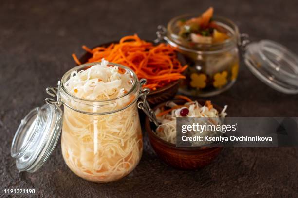 homemade canned vegetables. pickled cucumbers, cauliflowers, carrots and peppers in glass jar. - fermenting stock pictures, royalty-free photos & images