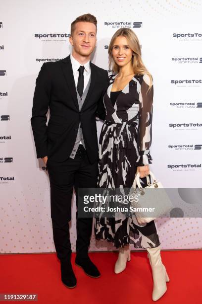 Marco Reus and Scarlett Gartmann attend the SportsTotal Christmas Party and foundation gala at Flora Koeln on December 01, 2019 in Cologne, Germany.