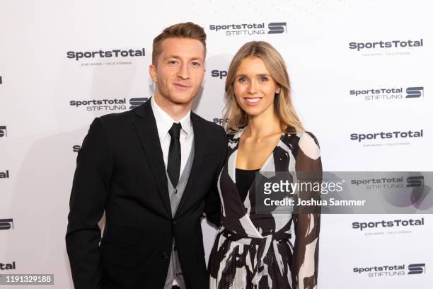 Marco Reus and Scarlett Gartmann attend the SportsTotal Christmas Party and foundation gala at Flora Koeln on December 01, 2019 in Cologne, Germany.