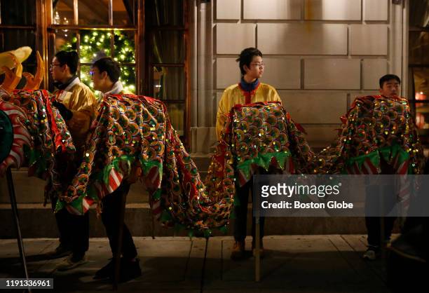 Members of the Greater Boston Chinese Cultural Association wait to march in the People's Procession during First Night festivities on New Year's Eve,...