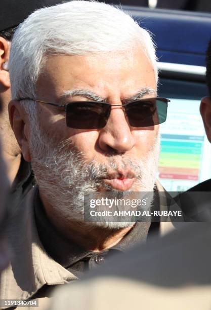 This photo taken on December 31, 2019 shows Abu Mahdi al-Muhandis, a commander in the Popular Mobilization Forces, attending the funeral procession...