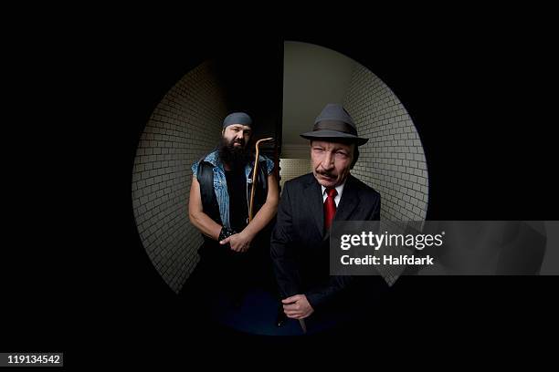 an organized crime boss with his bodyguard, viewed through a peephole - peephole stock-fotos und bilder