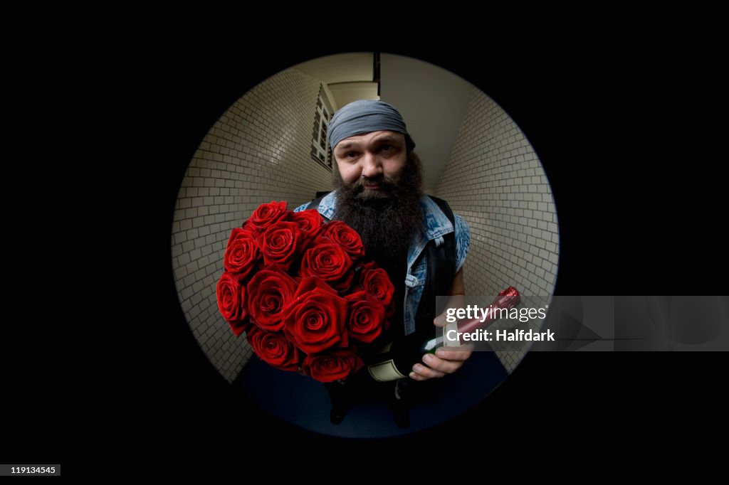 A Man Looking Apologetic With Roses And Champagne Viewed Through A ...