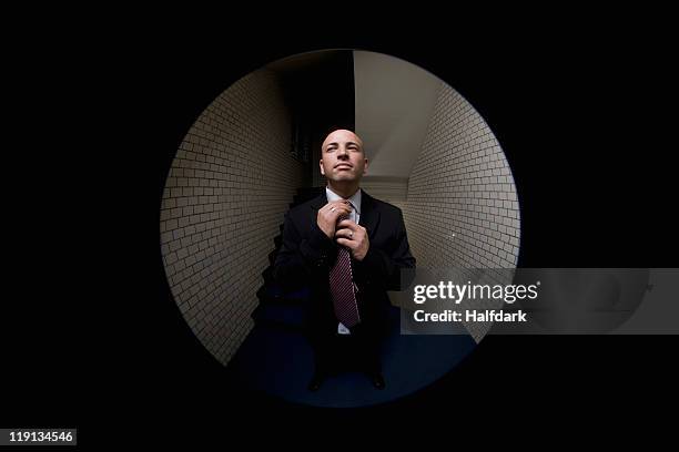 a man adjusting his tie, viewed through a peephole - kikhål bildbanksfoton och bilder