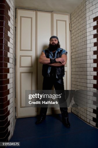 A bouncer standing in front of a door A bouncer standing in front of a door