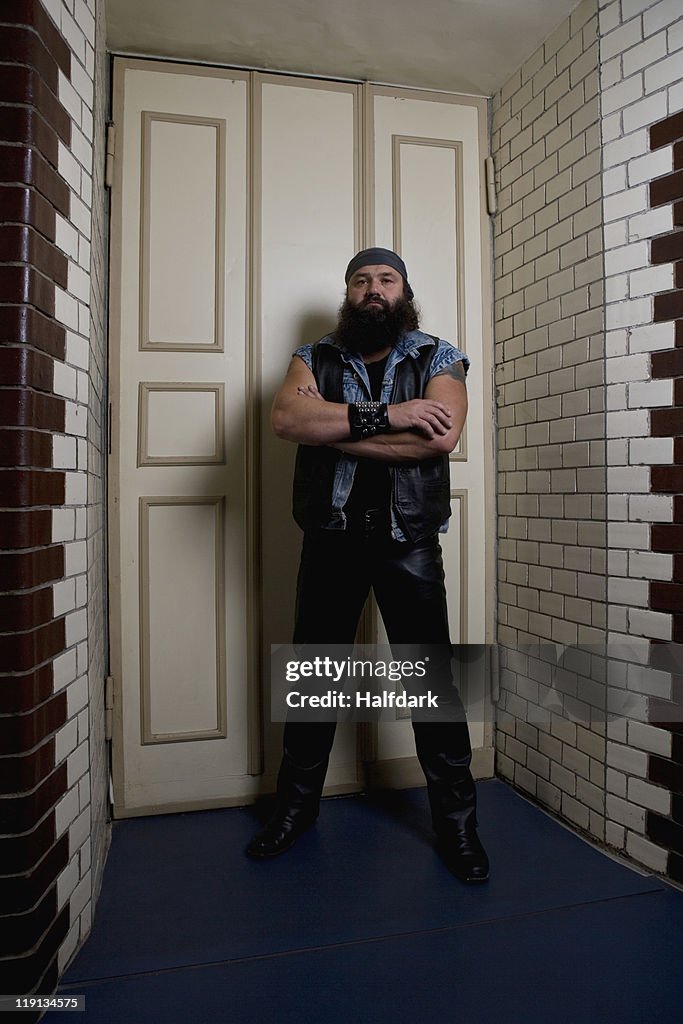 A bouncer standing in front of a door