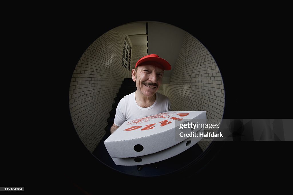 A pizza delivery man, viewed through peephole
