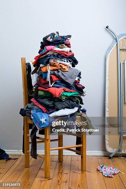 a big untidy stack of clean clothes waiting to be ironed - neat fotografías e imágenes de stock
