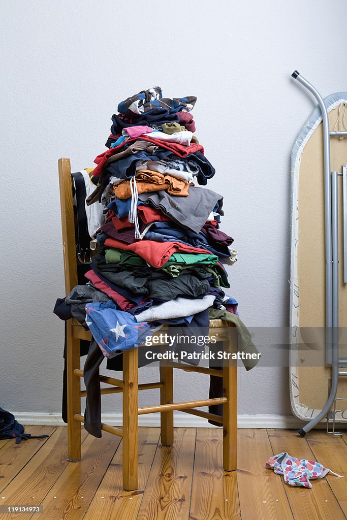 A big untidy stack of clean clothes waiting to be ironed