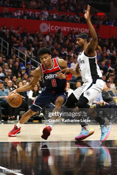 Rui Hachimura of the Washington Wizards drives around Maurice Harkless of the Los Angeles Clippers during the first half at Staples Center on...