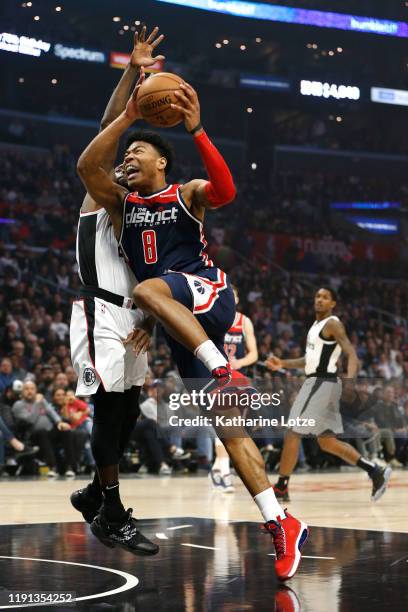 Rui Hachimura of the Washington Wizards dunks the ball as Patrick Beverley of the Los Angeles Clippers defends during the first half at Staples...