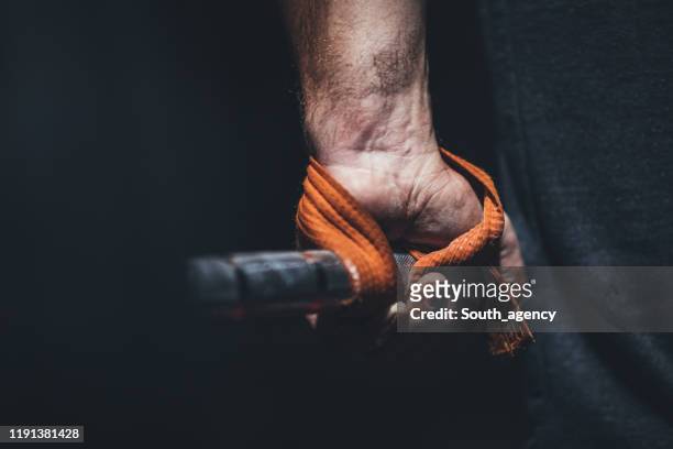guy gripping a barbell - strap stock pictures, royalty-free photos & images