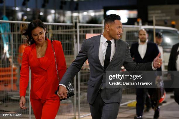 Maria Folau holds hands with husband Israel Folau as he acknowledges a supporter as he leaves Federal Court on December 02, 2019 in Melbourne,...