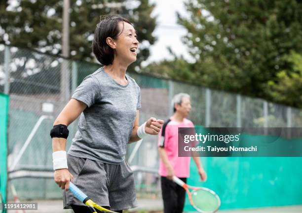 japanese women enjoying tennis with friends - tennis adult stock pictures, royalty-free photos & images