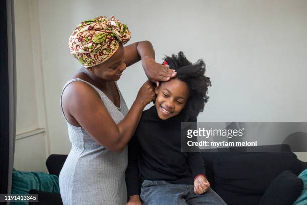 mother and daughter doing their hair - showus stock pictures, royalty-free photos & images