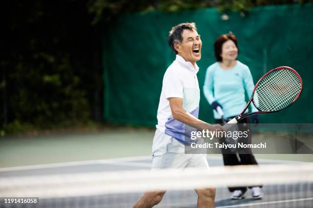 tennis team enjoying a doubles match - japanese respect stock pictures, royalty-free photos & images