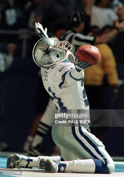 Deion Sanders of the Dallas Cowboys rejoices in the end zone after returning a punt for a touchdown in the fourth quarter against the Washington...