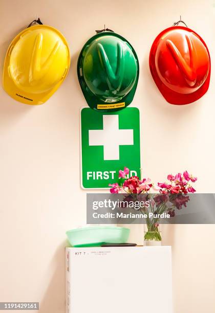 hard hats and a first aid box - workplace first aid kit stock pictures, royalty-free photos & images