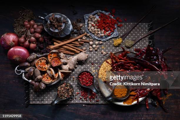 flat lay view of spices on wood backgrounds. - indian chef stock pictures, royalty-free photos & images
