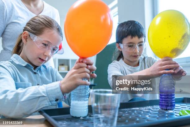 students doing colour experiment in laboratory - blowing up balloon stock pictures, royalty-free photos & images