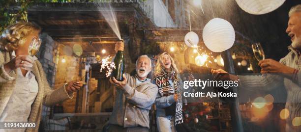 family new year's eve party. - champagne cork stock pictures, royalty-free photos & images