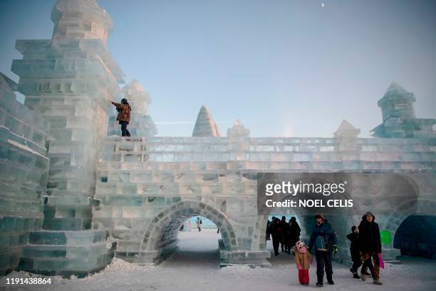 Worker gives finishing touches on an ice sculpture ahead of the opening of the Harbin International Ice and Snow Festival in Harbin, in China's...