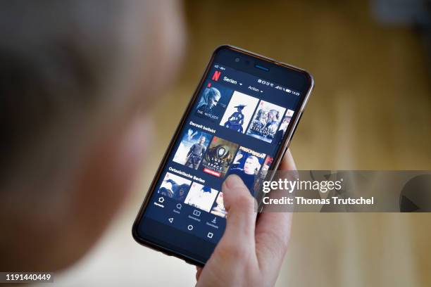 Berlin, Germany A woman looks at the NETFLIX app on her smartphone on January 03, 2020 in Berlin, Germany.