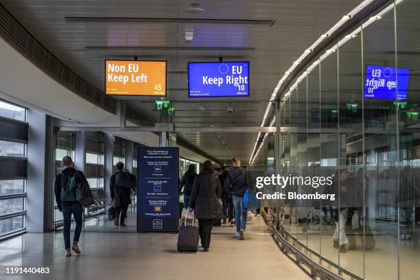 Digital signs direct arriving passengers to non-European Union , left, and EU passport clearance, right, at Dublin Airport in Dublin, Ireland, on...