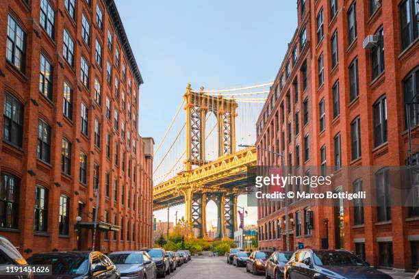 manhattan bridge at sunset seen from dumbo, brookyn, new york city - brooklyn new york stock pictures, royalty-free photos & images