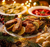 Christmas carp, Fried carp fish slices on a white plate  on a holiday table, close up.