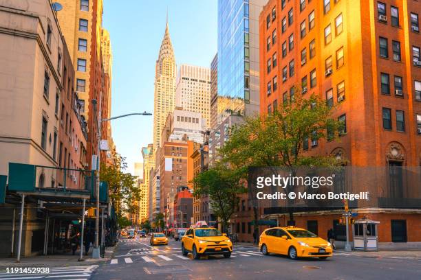 yellow taxis on manhattan streets, new york city - lower manhattan stock pictures, royalty-free photos & images