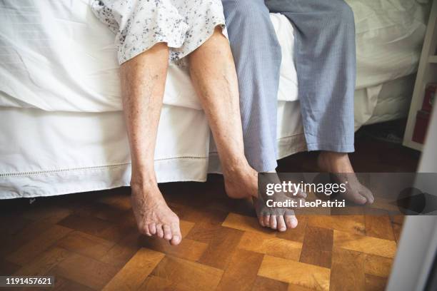 senior feet close up waking up - old man feet stock pictures, royalty-free photos & images