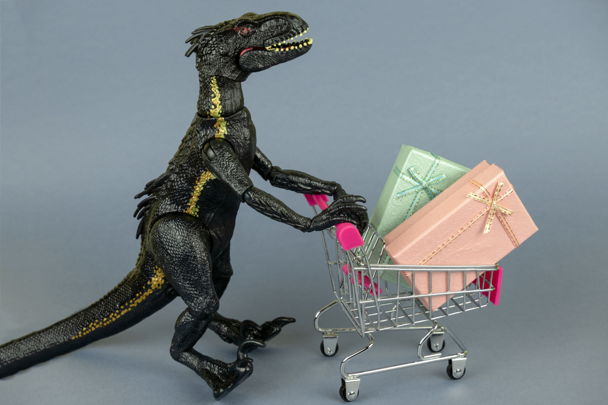 dinosaur toy with shopping cart full of present boxes dinosaur toy with shopping cart full of present boxes