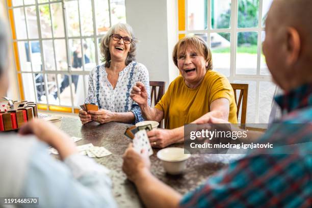 enjoyable card game with friends - senior men coffee stock pictures, royalty-free photos & images