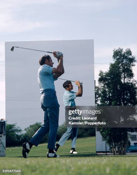 Bob Charles, New Zealand left-handed golfer and national sporting hero, uses a mirror during a practice session, circa 1970.