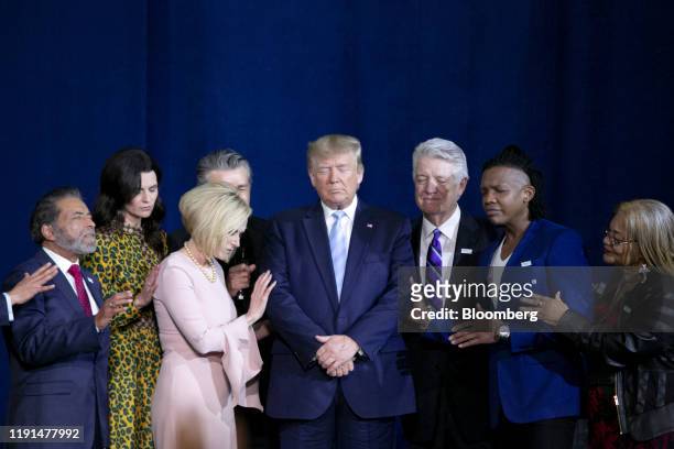 President Donald Trump, center, prays during an 'Evangelicals for Trump' Coalition launch event in Miami, Florida, U.S., on Friday, Jan. 3, 2020. The...