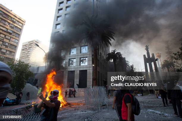 Protester takes a selfie during the first protest of the year against the government of President Sebastian Pinera, during which the San Francisco de...