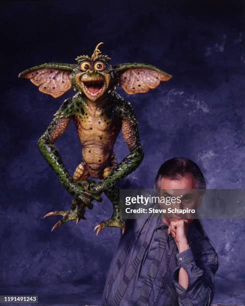 Portrait of American special effects artist Rick Baker as he poses with 'Daffy,' one of his creations from the film 'Gremlins 2: The New Batch' , Los...