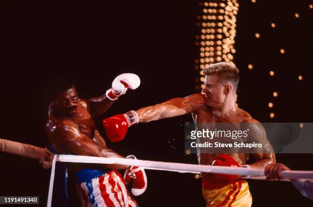 View of American actor Carl Weathers and Swedish actor Dolph Lundgren as they box in a scene from the film 'Rocky IV' , Los Angeles, California, 1984.