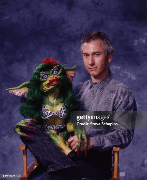 Portrait of American special effects artist Rick Baker as he poses with 'Greta,' one of his creations from the film 'Gremlins 2: The New Batch' , Los...