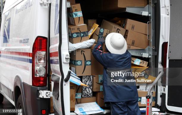 Postal Service worker unpacks packages from a truck on December 02, 2019 in San Francisco, California. Cyber Monday shoppers are on track to spend a...