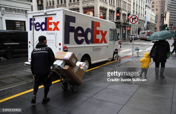 FedEx worker pushes a cart stacked with packages on December 02, 2019 in San Francisco, California. Cyber Monday shoppers are on track to spend a...