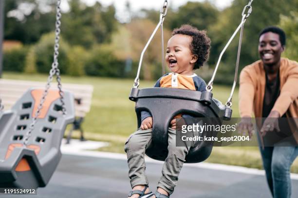 mutter und kleinkind auf dem spielplatz - mother and son at playground stock-fotos und bilder