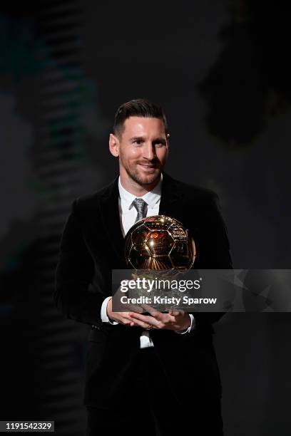 Lionel Messi poses onstage after winning his sixth Ballon D'Or award during the Ballon D'Or Ceremony at Theatre Du Chatelet on December 02, 2019 in...