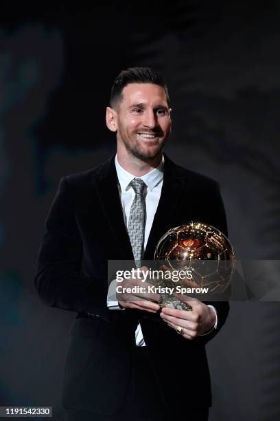 Lionel Messi poses onstage after winning his sixth Ballon D'Or award during the Ballon D'Or Ceremony at Theatre Du Chatelet on December 02, 2019 in...