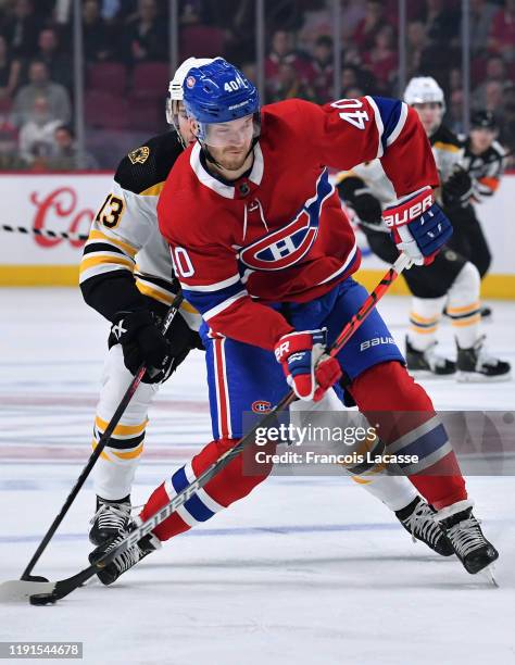 Joel Armia of the Montreal Canadiens passes the puck against the Boston Bruins in the NHL game at the Bell Centre on November 26, 2019 in Montreal,...